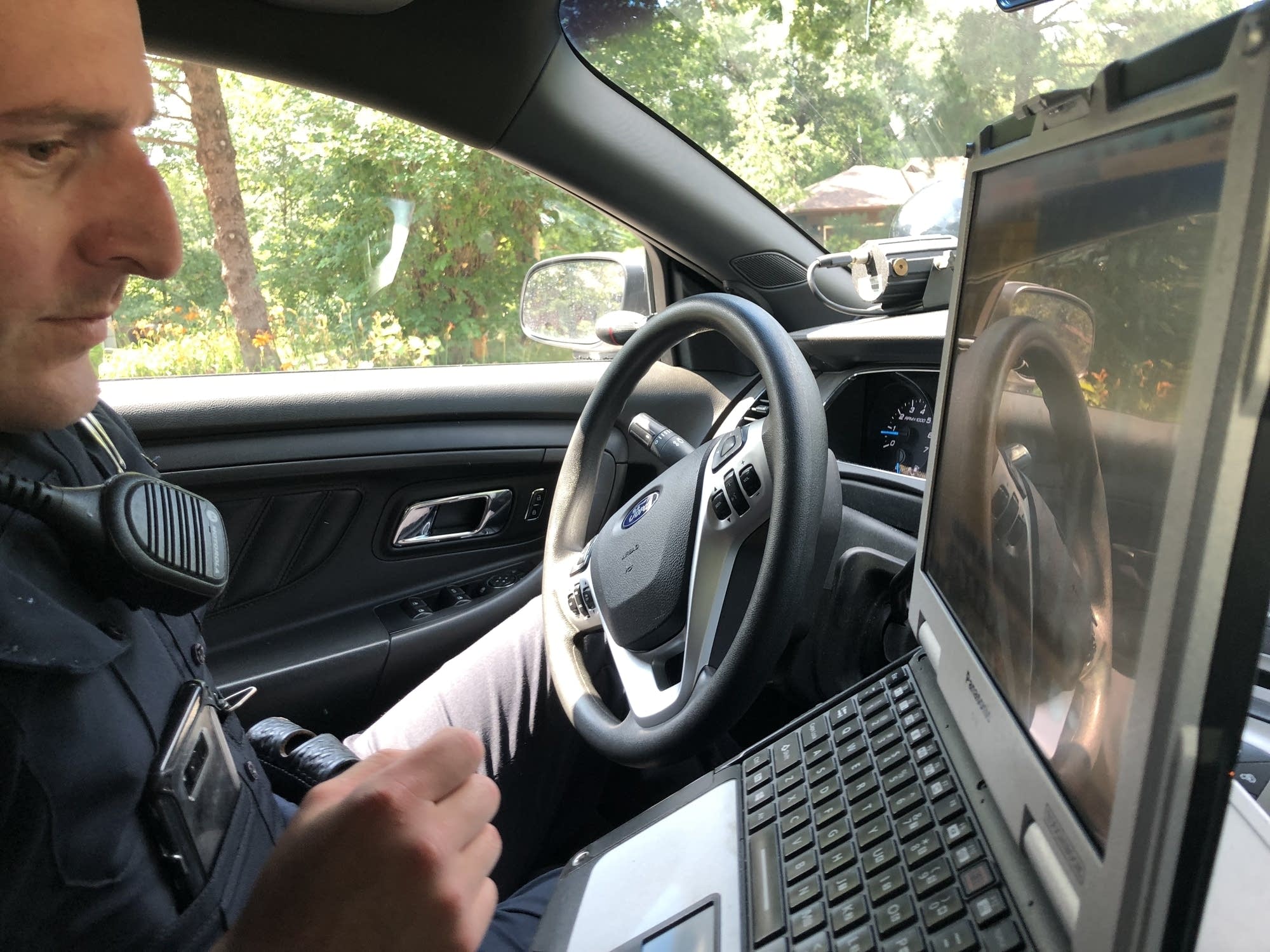 Minnetonka Police Officer Patrick Eggleston checks his squad monitor.