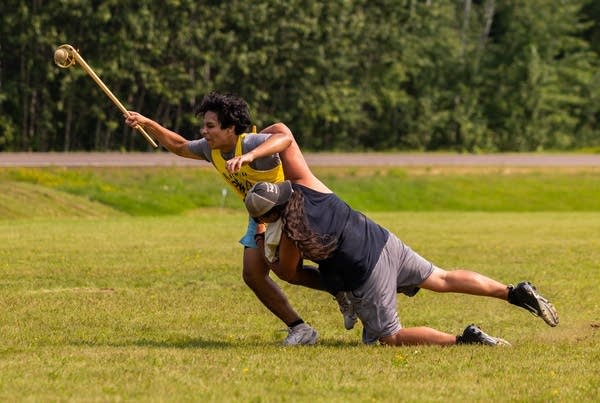 two people playing stickball