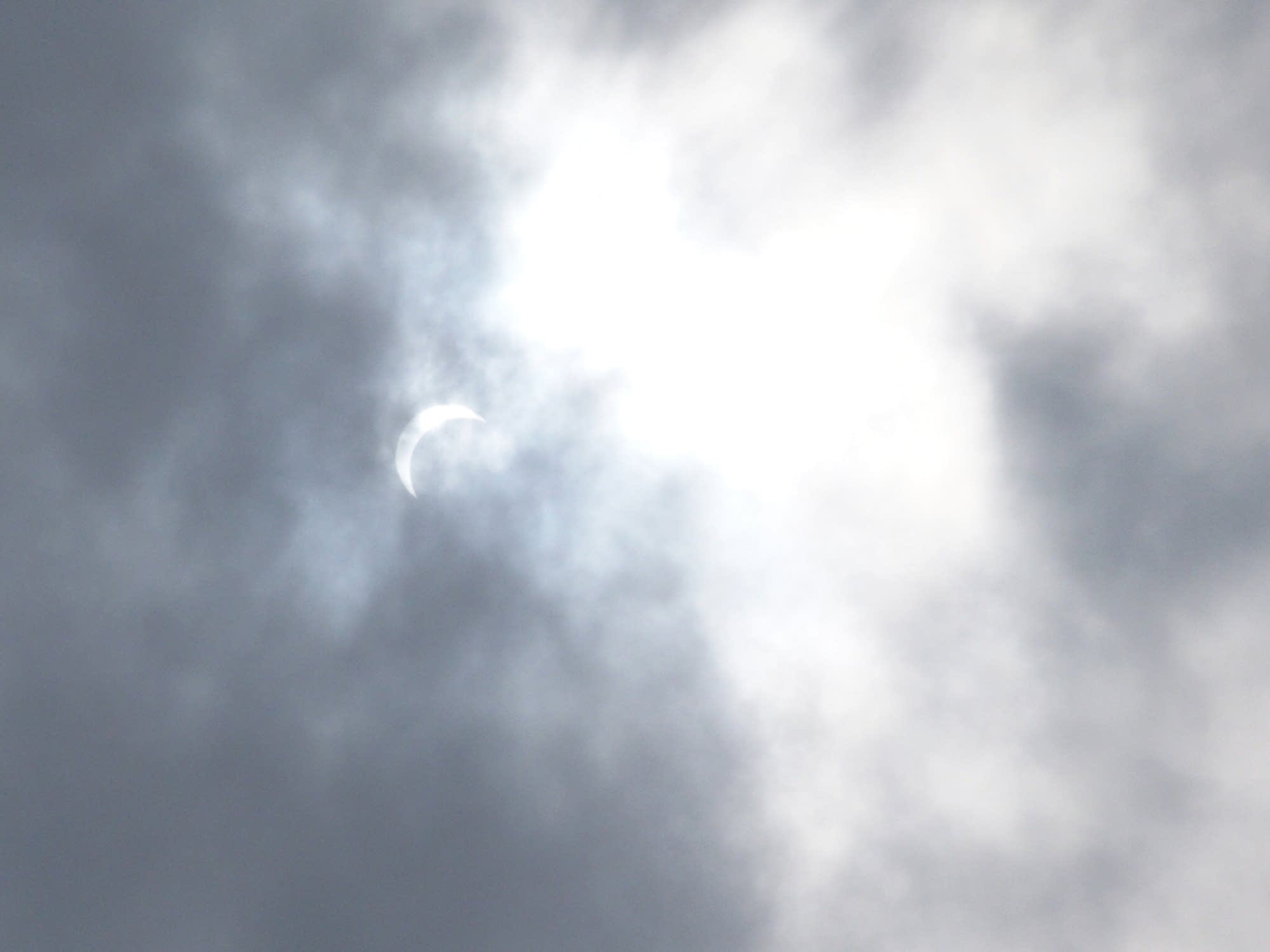 The eclipse through the clouds along the St. Croix.