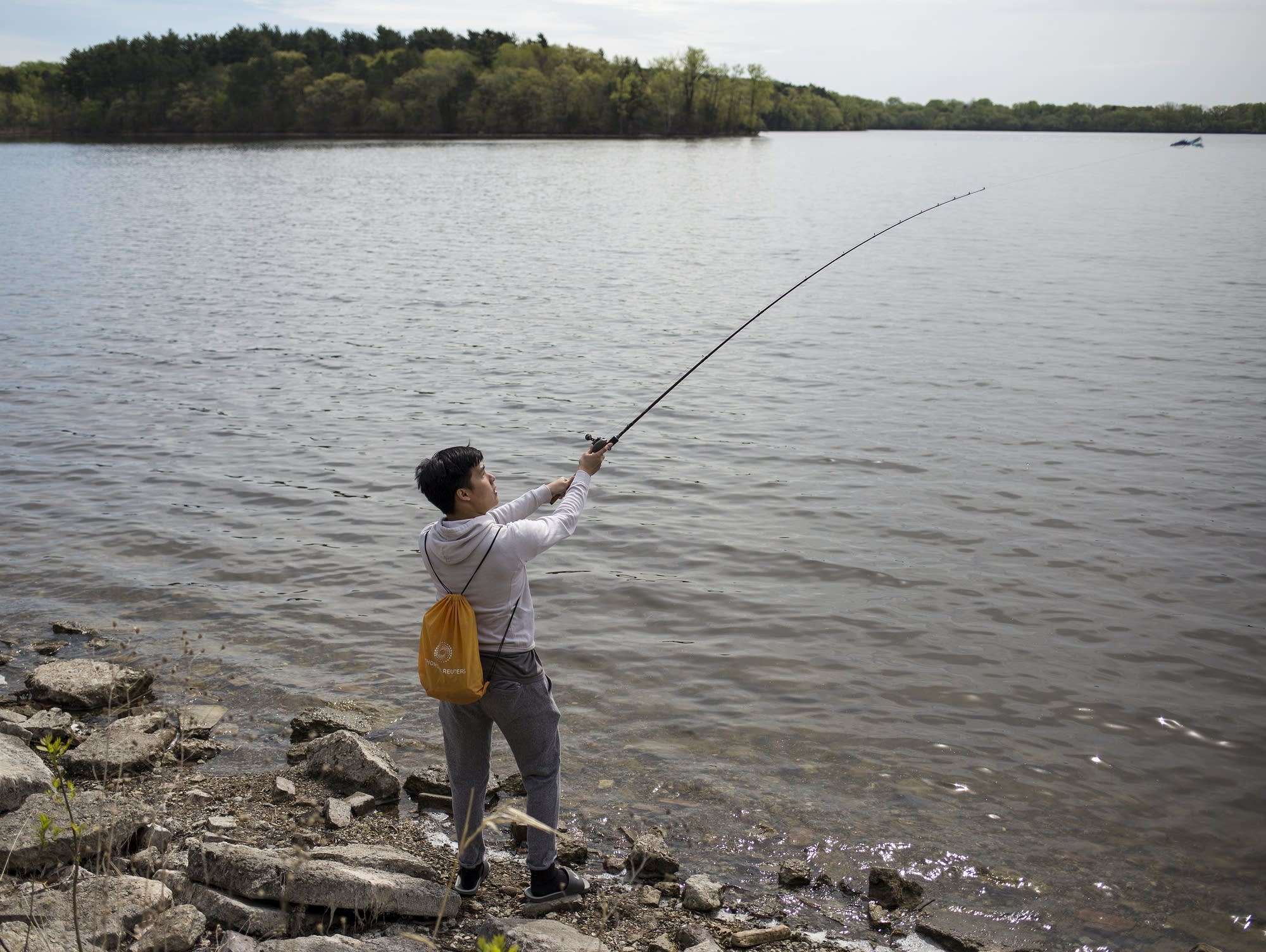 Nikls Chang of St Paul casts his line at Vadnais Lake