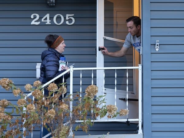 Liz Boldon  talks to a voter while door-knocking 