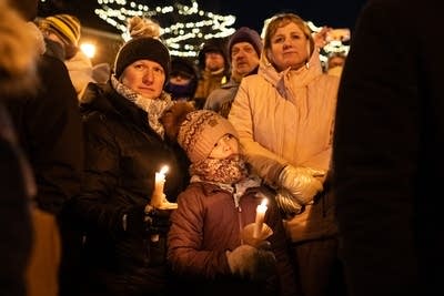 A woman and her daughter at a vigil-1