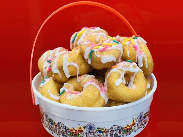 A bucket with small donuts.