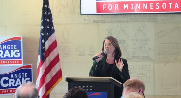 A woman speaks from a podium