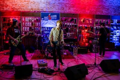 A band performing onstage in a nontraditional music venue