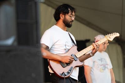 the band oeurth performing on stage outdoors