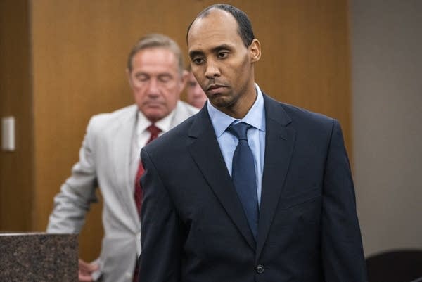 Mohamed Noor walks to the podium to be sentenced