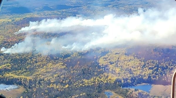 An aerial view of smoke rising from a wildfire