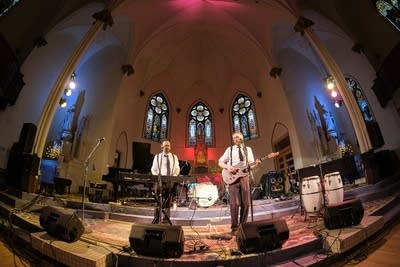 Two musicians performing onstage