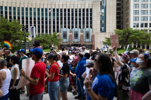 People wait in line outside a government building