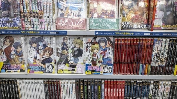 Japanese manga comic books and novels are displayed at a book store.