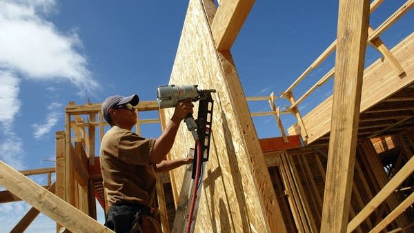 A construction worker builds the frame for a new home in Rodeo, California. 
