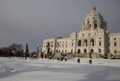 Law%20enforcement%20stands%20outside%20a%20state%20capitol.%20