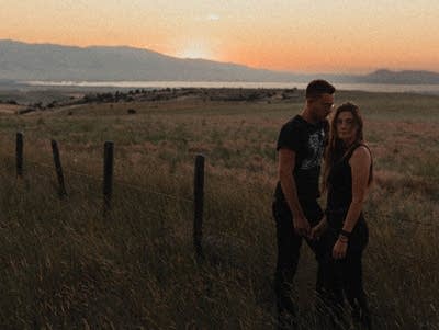 Two people standing in a field