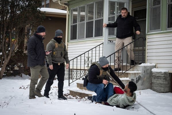 Federal agents detain a Black man