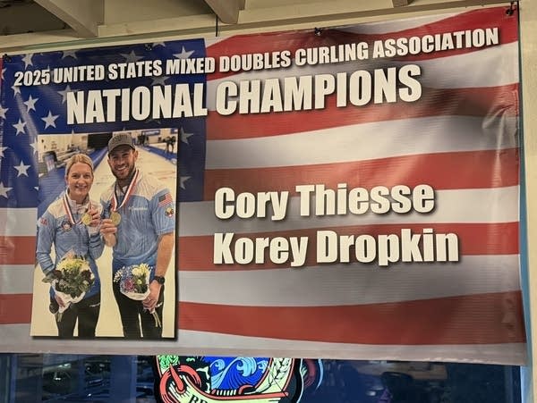A banner celebrates two champion curlers