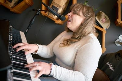 A musician sings and plays piano at a coffeehouse