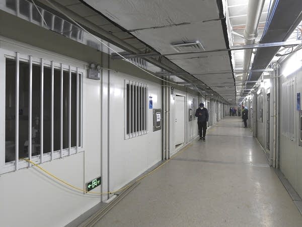 People walk down a corridor at the Huoshenshan temporary field hospital