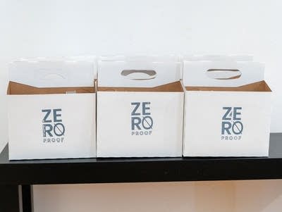 Three cardboard six-pack containers with Zero Proof lettering.