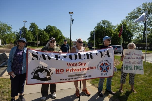Veterans hold a protest banner