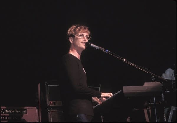 A man sings and plays keyboards onstage