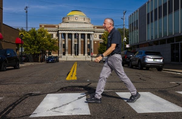 A person crosses a crosswalk