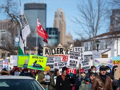 People take part in a march down a city street