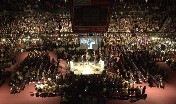 An Honor Guard walks across the stage during a public memorial service.