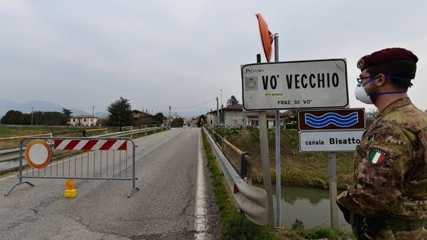 An Italian soldier patrols by a check-point at the entrance of the small town of Vo Vecchio, situated in the red zone of the COVID-19 the novel coronavirus outbreak, northern Italy, on February 24, 2020.