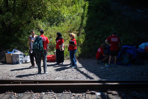 A man speaks with outreach workers
