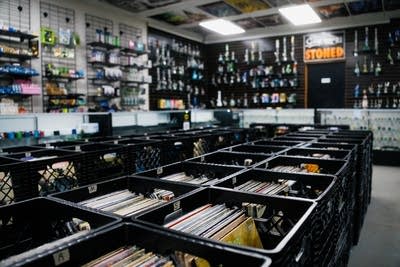 Rows of records and throngs of bongs on display in a record store