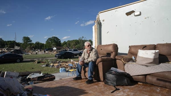 Raymond Samples sits on his relative's sofa after a tornado in London, Kentucky, on May 17, 2025. Severe storms that swept through Missouri, Kentucky, and Virginia left more than 25 people dead. 