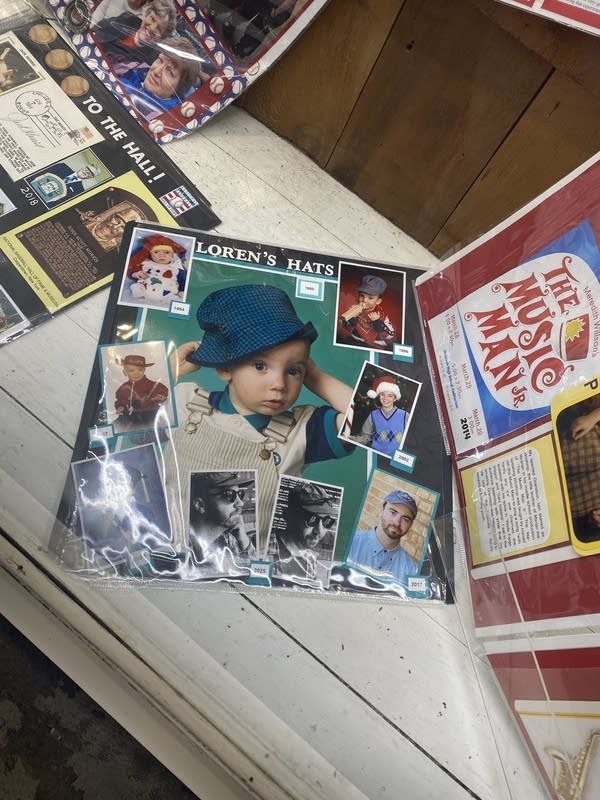 A scrapbook page featuring a boy at various ages in different hats. The title says, "Loren's Hats."
