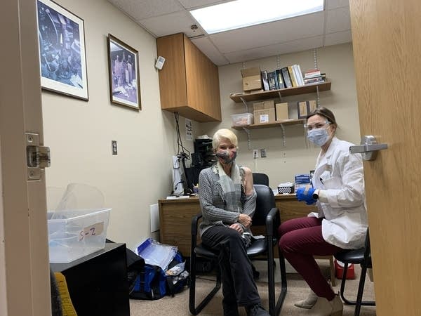 A woman waits to get vaccinated against COVID-19. 