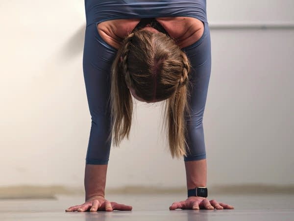 Lynn Lunny, co-owner of Stomping Ground Studio, performs a handstand in her Northeast Minneapolis studio on Wednesday, May 4, 2022. Lunny will be participating in the upcoming show "Touching Two Worlds: An Evening of Circus Arts & Storytelling."
