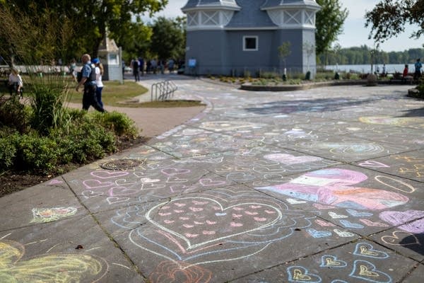 Chalk hearts cover a sidewalk