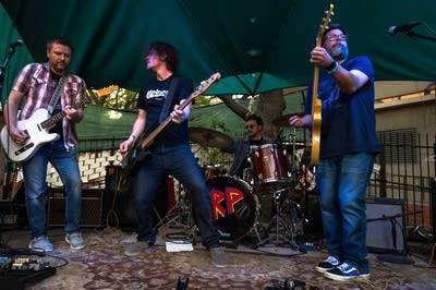 a rock band performing on an outdoor stage