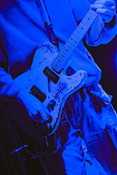 Close up of person playing guitar