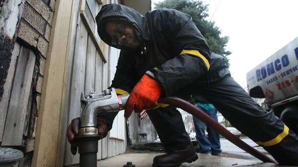 Above, man delivers home heating oil in the Bronx.