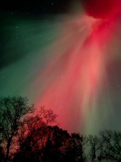 Reds and greens cover the night sky.