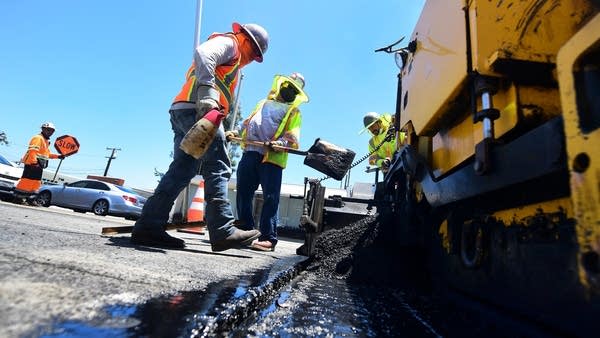 The Department of Labor is preparing updates to the regulations of federally funded construction jobs. Above, a crew resurfaces a road in Alhambra, California.