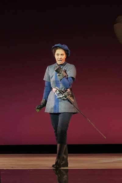 A singer performs onstage during an opera