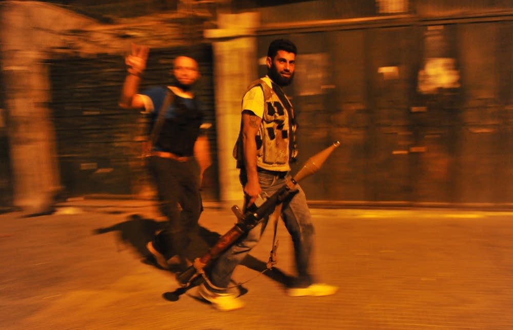 Free Syrian Army rebels walk in the stre
