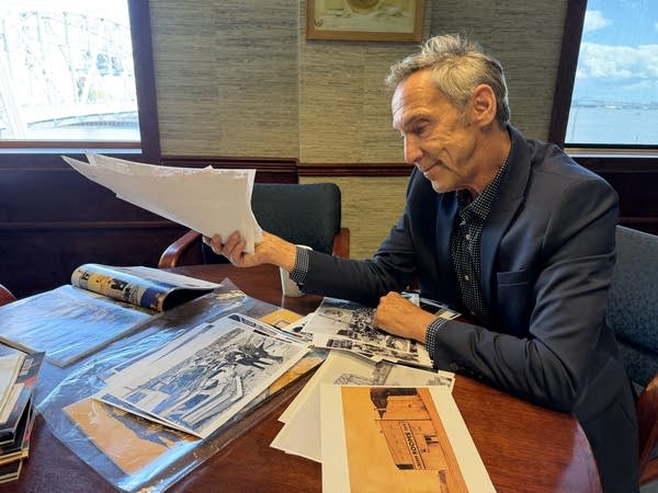 A person flipping through historic photos