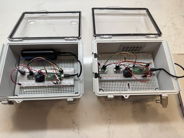 two boxes with electrical components in them