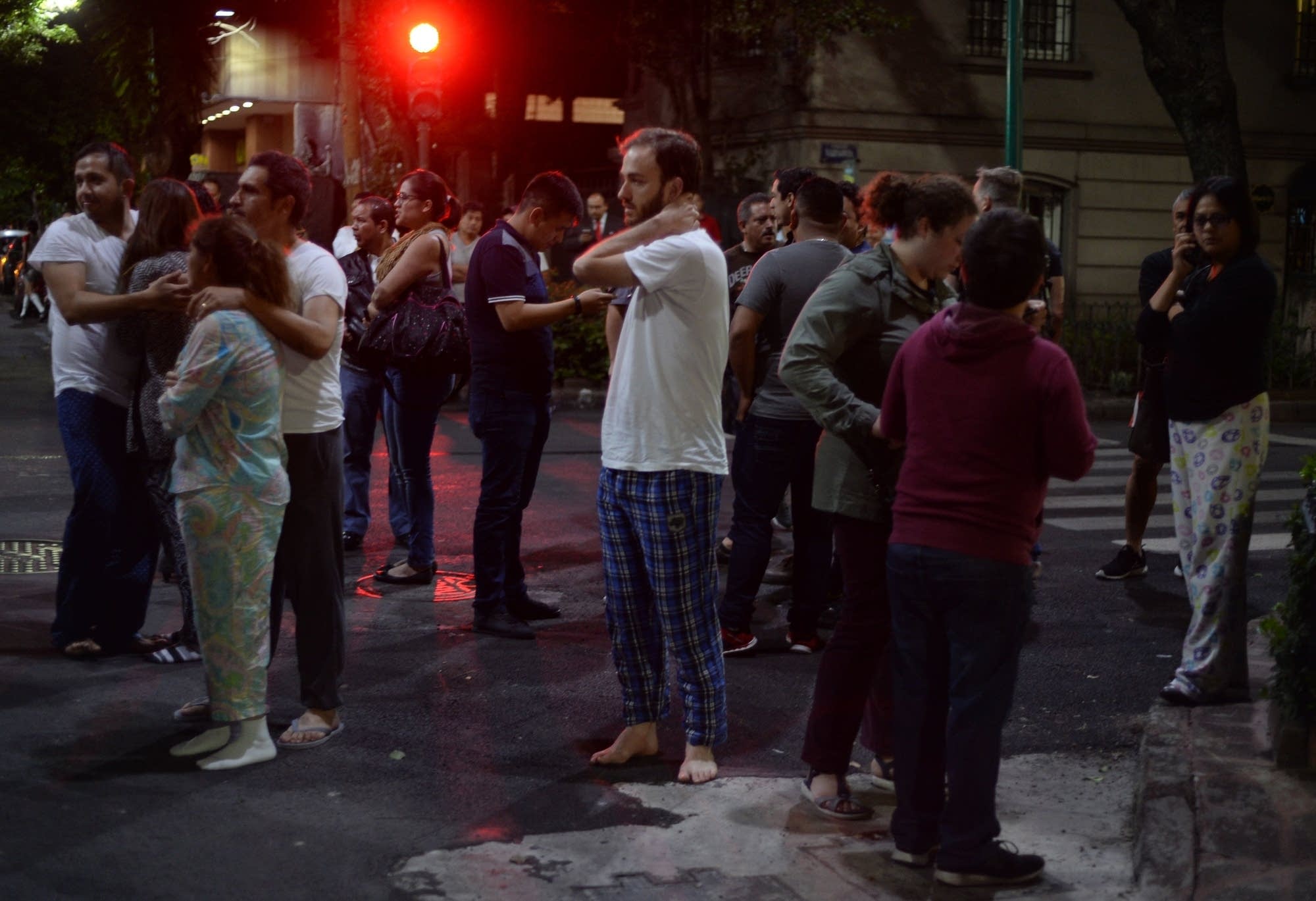 People gather on a street in downtown Mexico City during an earthquake.
