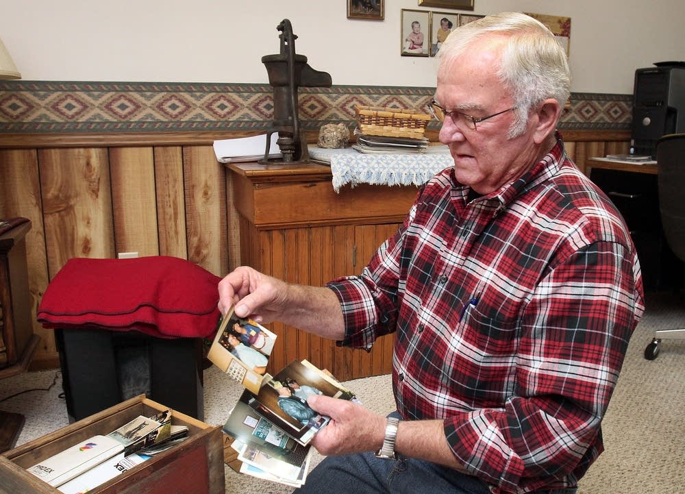 Galen Bungum looks at photos from his army days.