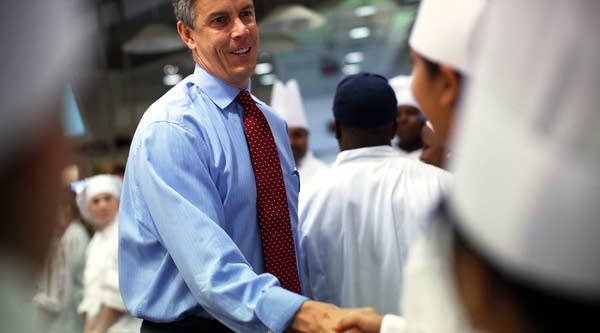Then-Secretary of Education Arne Duncan meets with student chefs during a high school culinary contest in 2012.