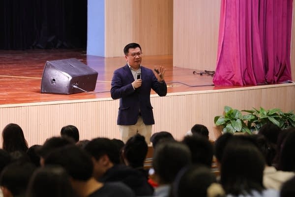 Wan Xiaofeng talks to a group of high school students and their families in Ningbo city, east China's Zhejiang province in April 2025