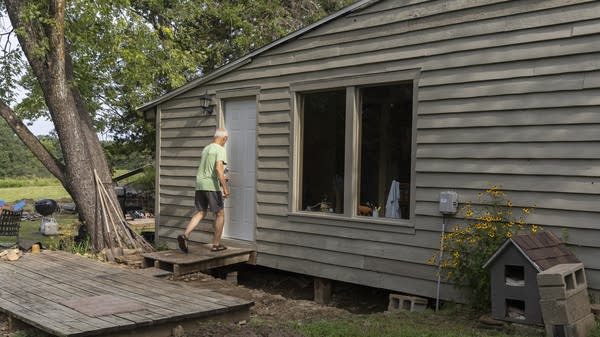 A man walks through a door.